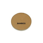 Round brown compact with 'BAMBOO' text on a white background