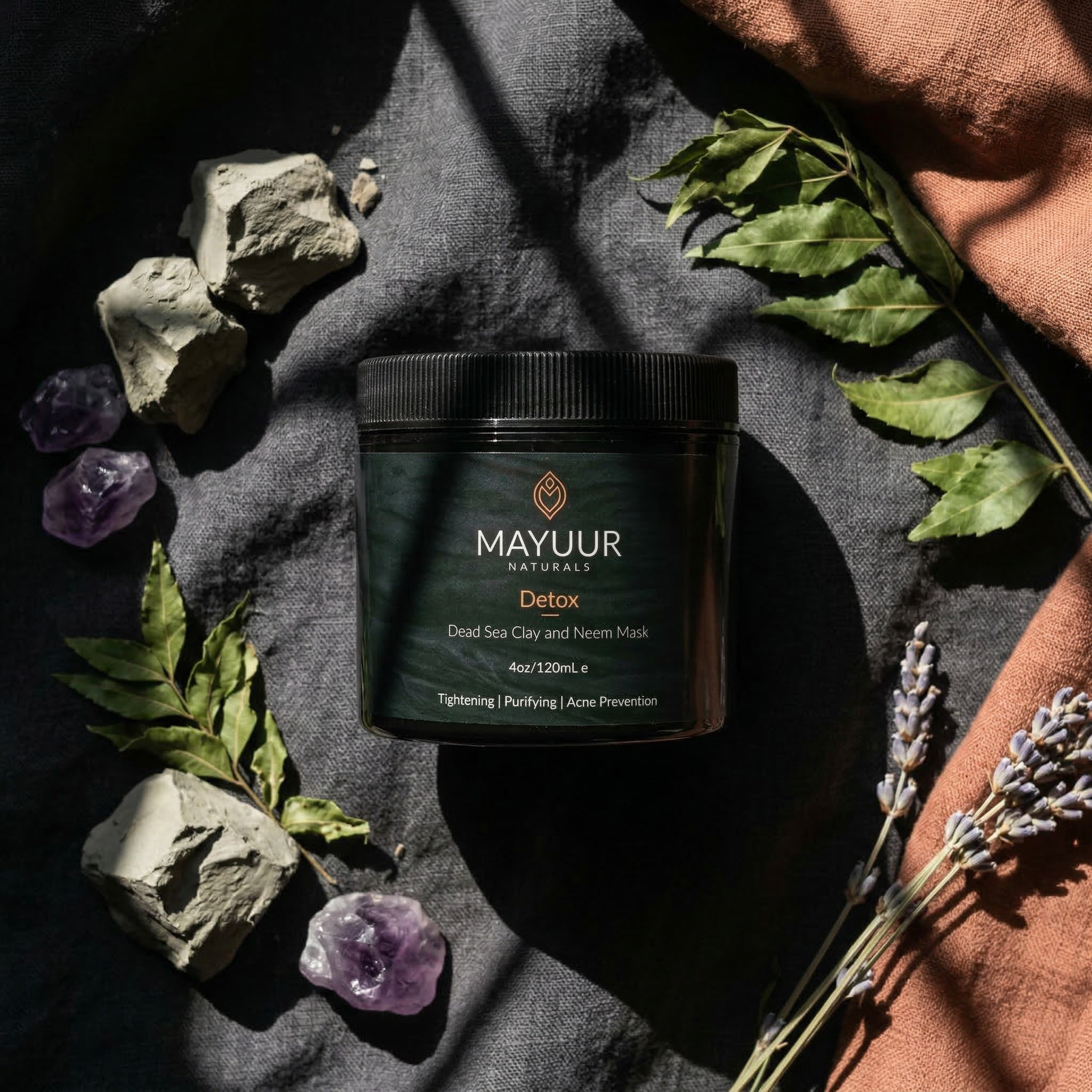 Mayuur Naturals Detox product on a dark fabric background with natural elements.