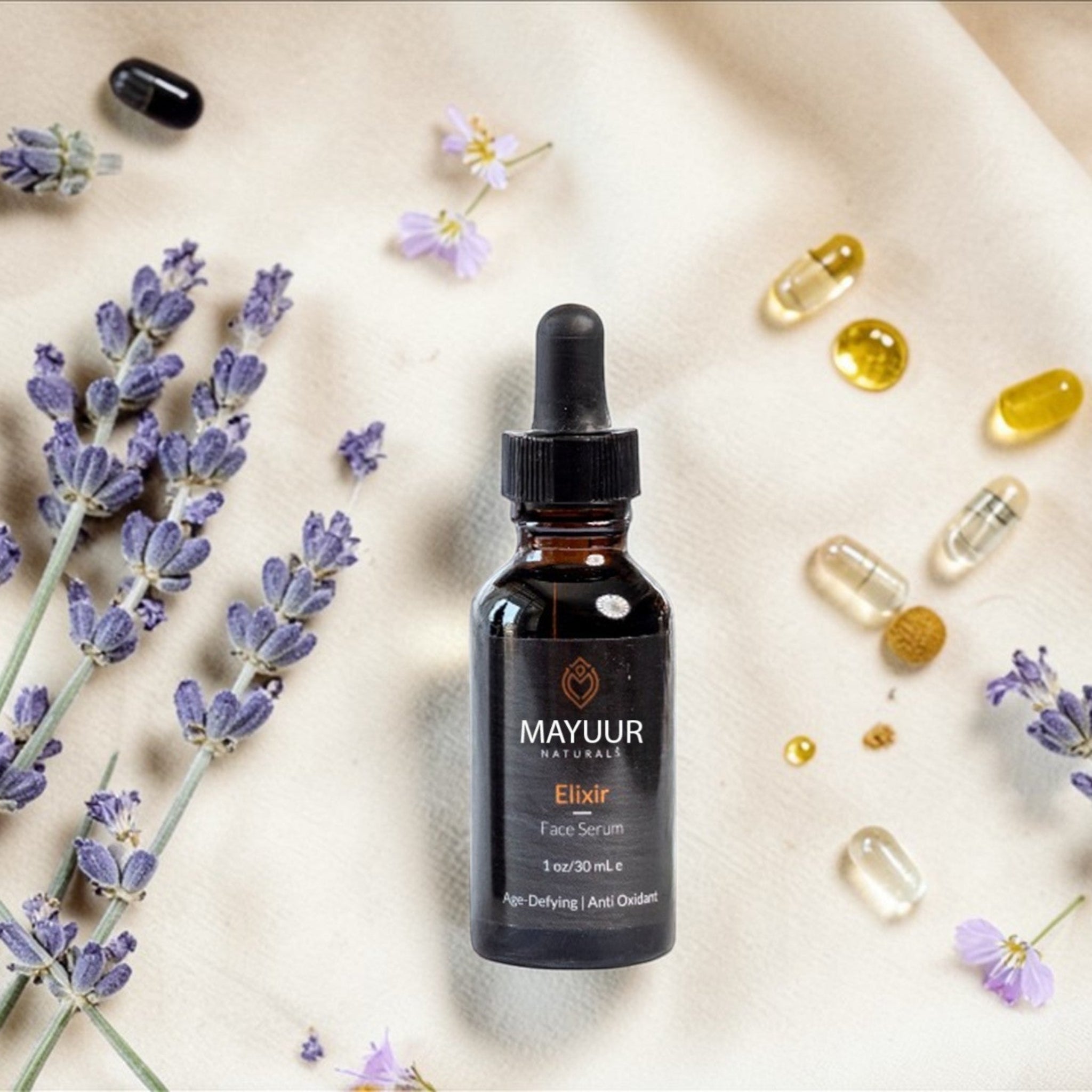 Mayuur Elixir bottle with lavender flowers and capsules on a light background