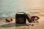 Mayuur body butter jar with ingredients on a wooden surface