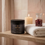 Mayuur body butter jar on a shelf with a candle and dried flowers in the background