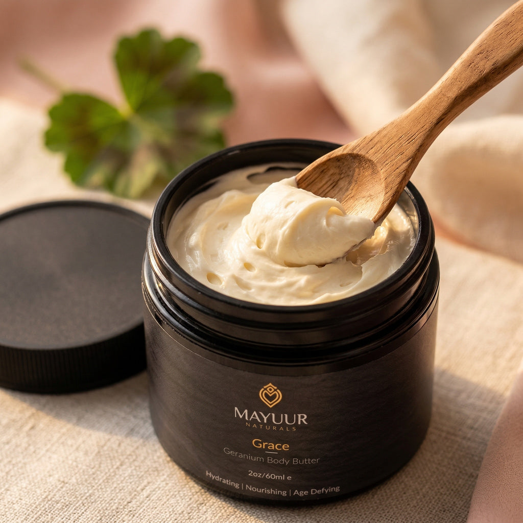Mayuur Naturals Geranium Body Butter jar with a wooden spoon scooping out cream.
