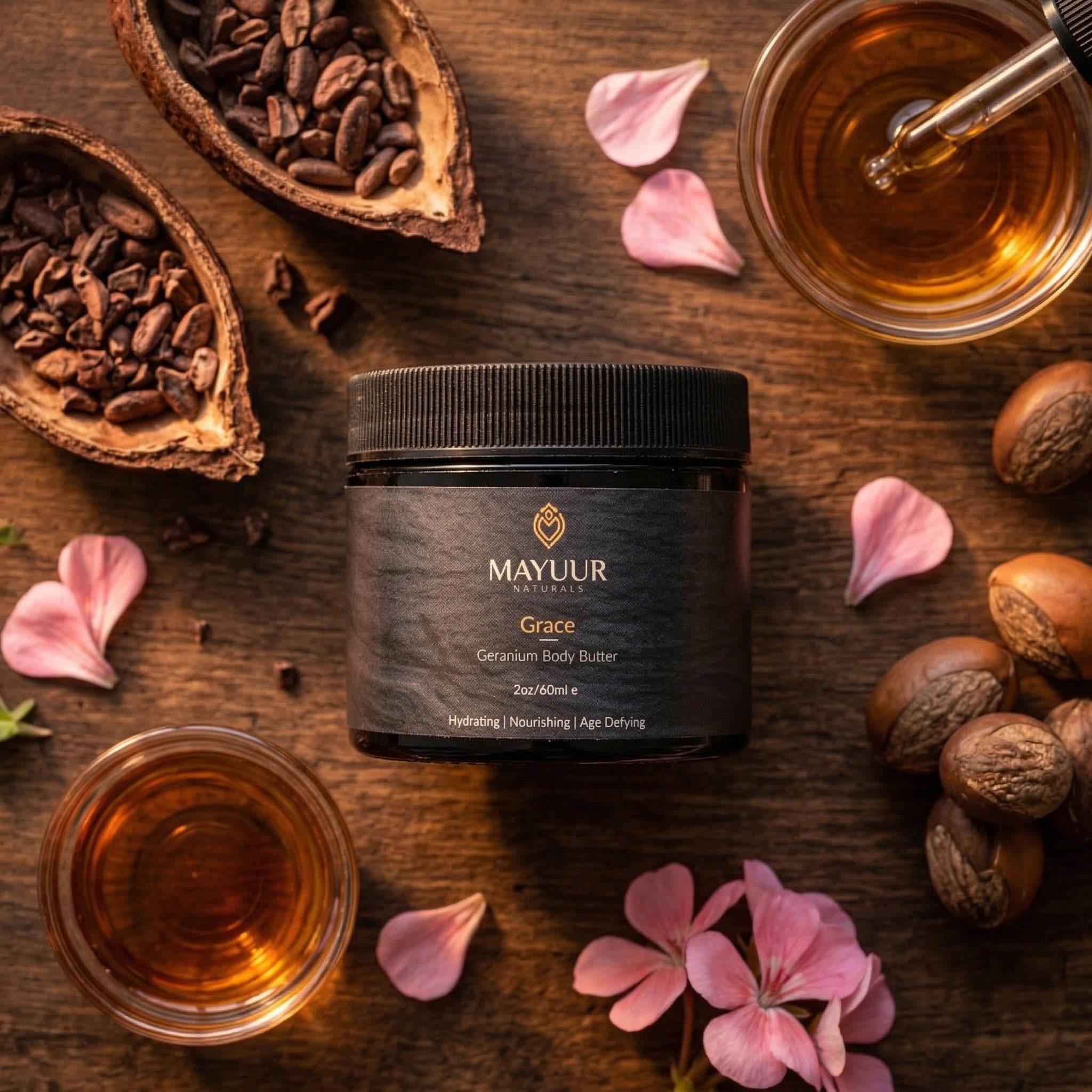 Mayur Grace Geranium Body Butter jar on a wooden surface with flowers and nuts.