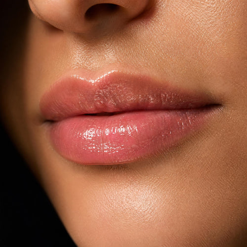 Close-up of a person's lips with a glossy lip color