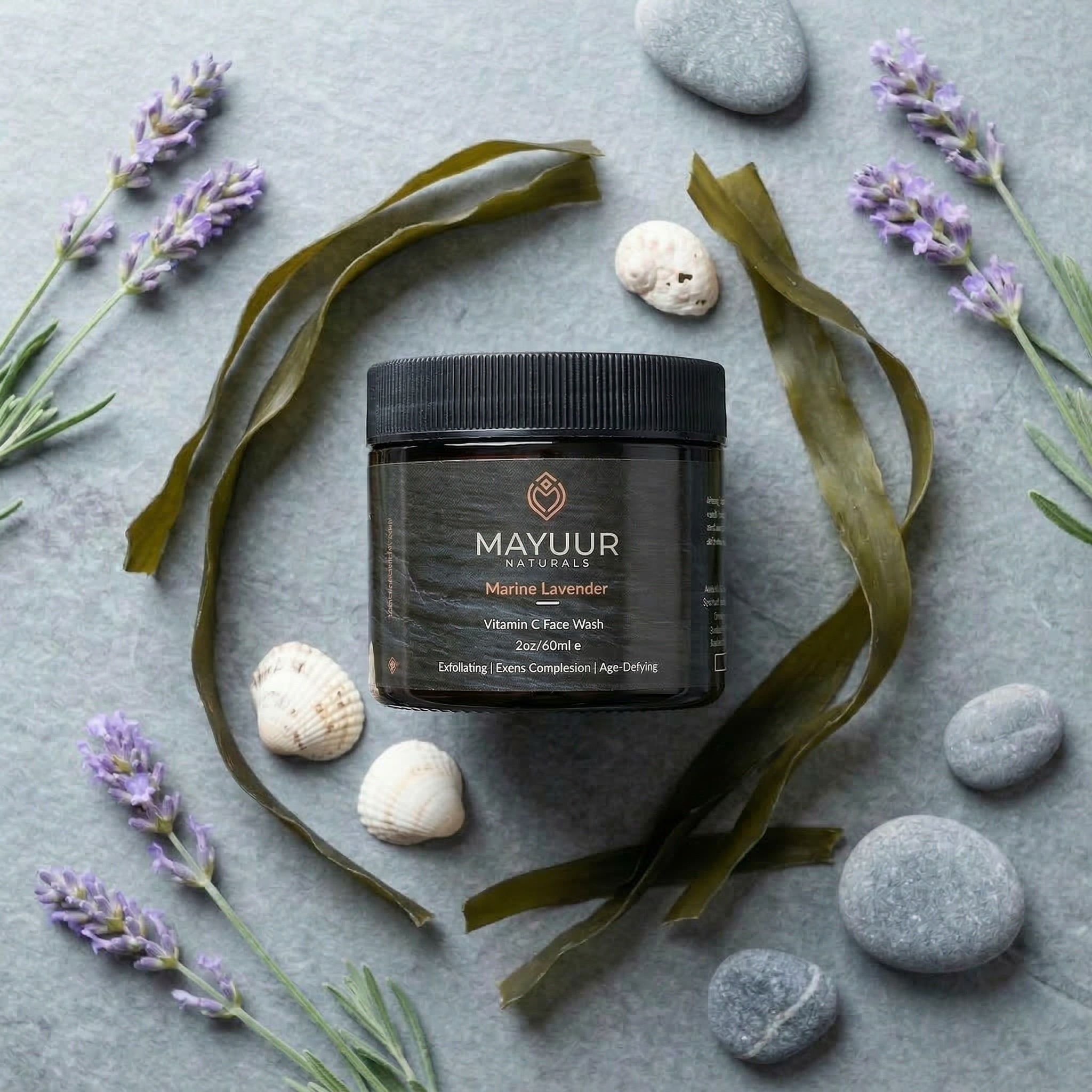 Mayuur Naturals jar with lavender flowers and seaweed on a gray background