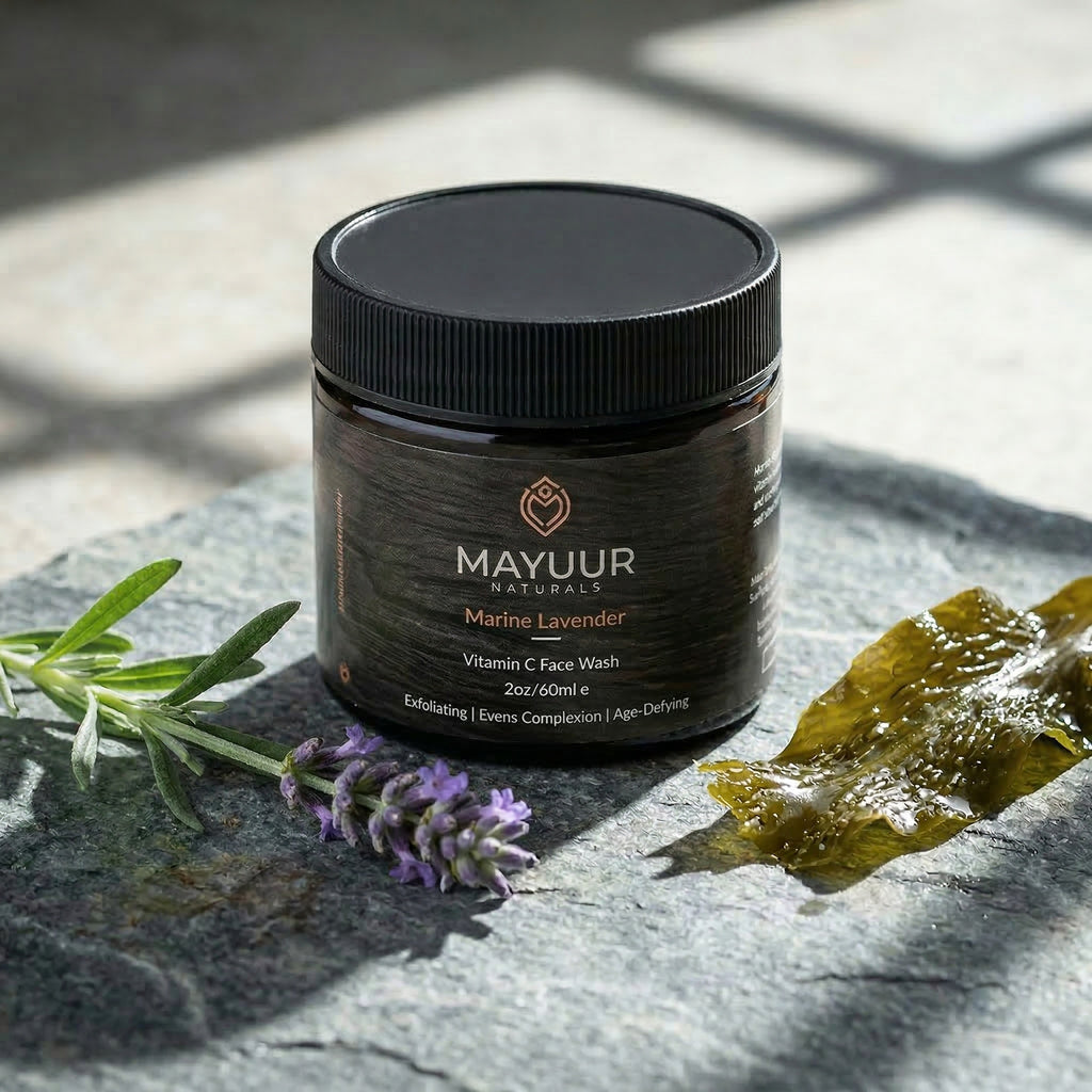 Mayuur Marine Lavender face wash jar on a stone surface with lavender and seaweed.
