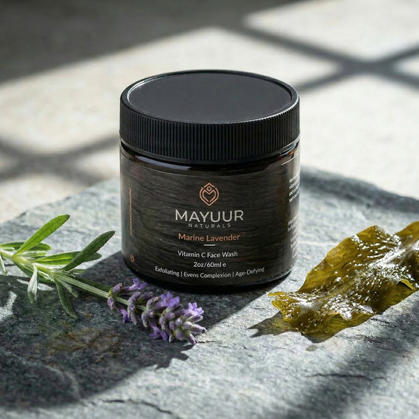 Mayuur Marine Lavender face wash jar on a stone surface with lavender and seaweed.
