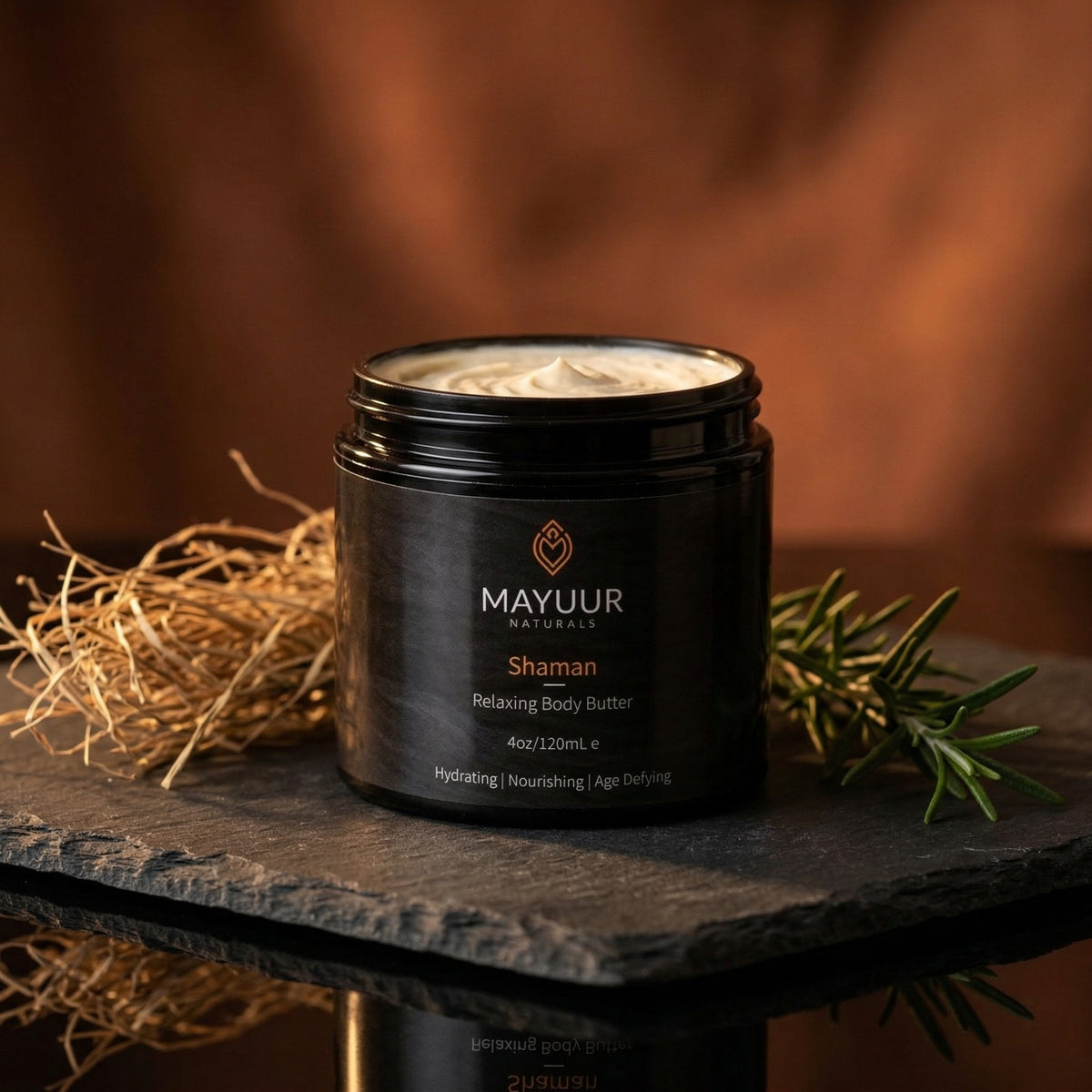 Mayuur Shaman Body Butter jar on a slate surface