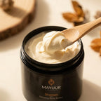 Mayuur Shaman Relaxing Body Butter jar with a wooden spoon scooping out cream.